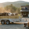 PrimeLoad Trailers dealership lot at golden hour with utility and dump trailers