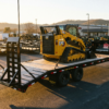 Heavy duty 7x20 equipment trailer with a skid steer loaded on the deck — equipment trailers for sale at PrimeLoad