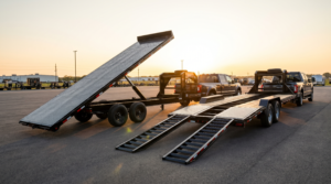 Side-by-side comparison of a hydraulic tilt deck equipment trailer and a slide-in ramp equipment trailer — equipment trailer tilt vs ramp at PrimeLoad